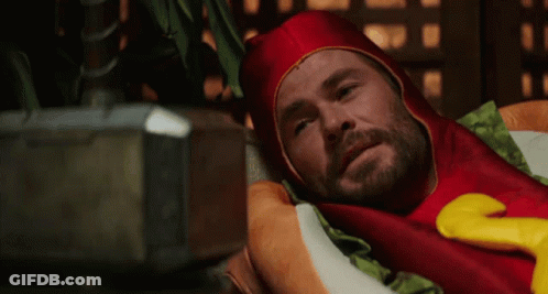 Man In Hot Dog Costume Laying On Pillow GIF