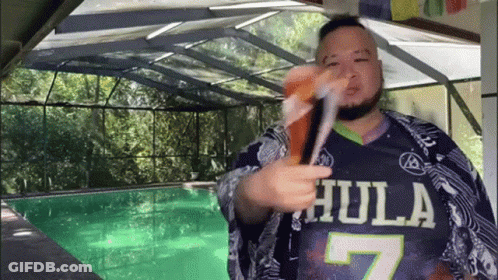 Man In Hula 7 Jersey Holding Drink GIF