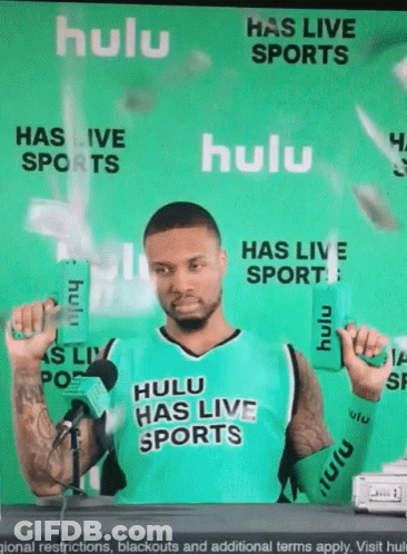 Man In Hulu Has Live Sports Jersey Holding Two Boxes GIF