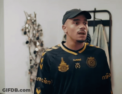 Man In Hummel Jersey In Front Of Clothes Rack GIF
