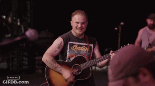 Man In Indian Motorcycles Shirt Playing Guitar GIF