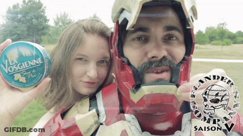 Man In Iron Man Costume Holding Can Of Vosgienne GIF
