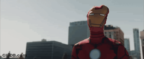 Man In Iron Man Costume In Front Of City GIF