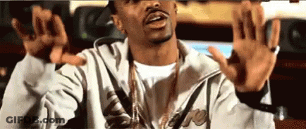 Man In Jacket And Necklace Making Funny Face Arms Up GIF