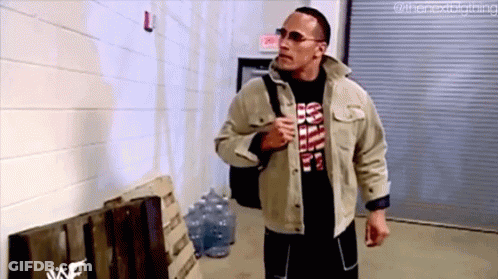 Man In Jacket And Sunglasses Walking Down Hallway With Backpack GIF