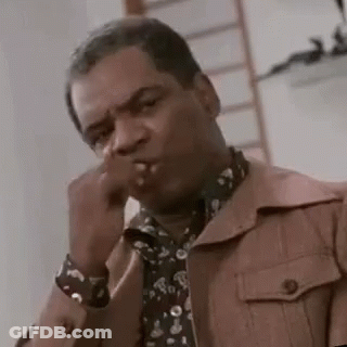 Man In Jacket And Tie Smoking Cigarette Covering Mouth GIF