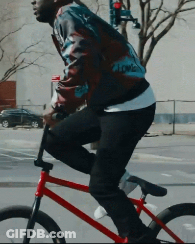 Man In Jacket Saying Love Riding Red Bike GIF