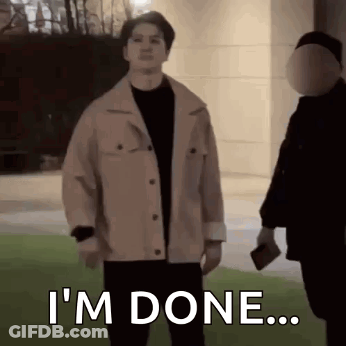 Man In Jacket Standing Next To Man In Mask GIF