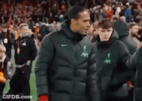 Man In Jacket Walking On Soccer Field With Boy GIF