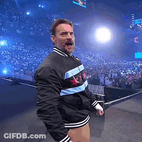 Man In Jacket With Chicago Star Stands Before Crowd GIF