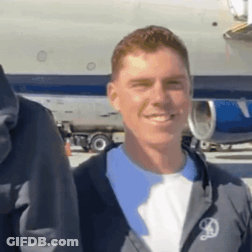 Man In Jacket With Letter D Smiling GIF