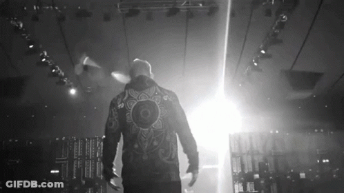 Man In Jacket With Mandala Walking On Stage GIF