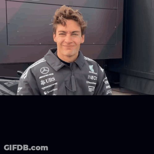 Man In Jacket With UBS And INEOS GIF