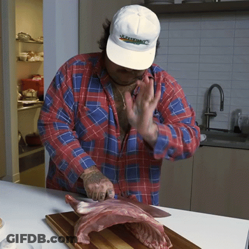 Man In Jacksonville Hat Cutting Meat GIF