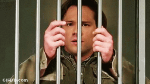 Man In Jail Cell Holding Bars GIF