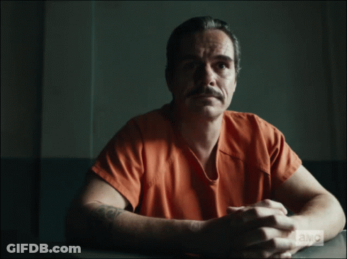 Man In Jail Cell With Money On Arm GIF