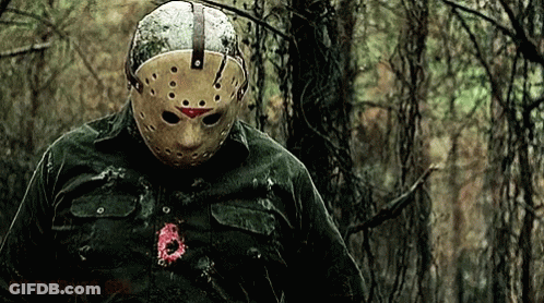 Man In Jason Voorhees Mask In Woods GIF