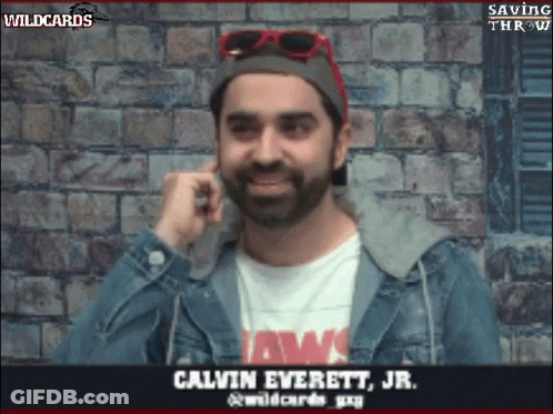 Man In Jaws Shirt And Denim Jacket Talking On Phone GIF