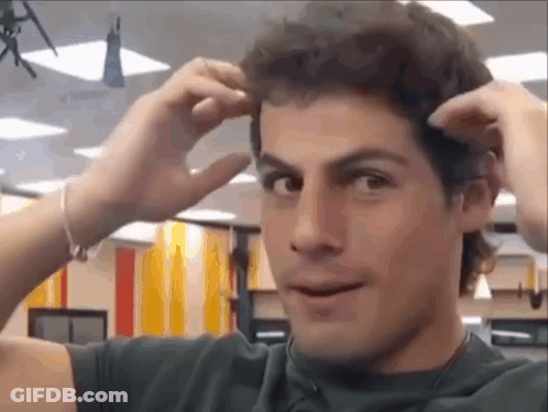 Man In Jeff 52 Jersey In Front Of Clock GIF