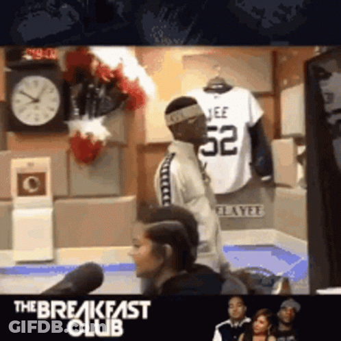 Man In Jeff 52 Jersey Stands In Front Of Clock GIF