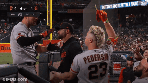 Man In Jersey 23 In Front Of Detroit Roots Sign GIF