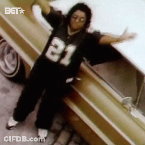Man In Jersey Number 21 Standing Next To Car GIF