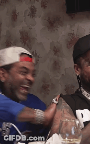 Man In Jersey Number 9 Laughing With Another Man GIF