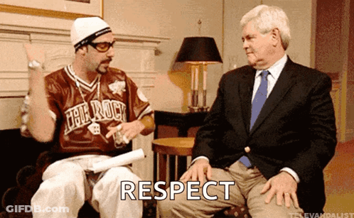 Man In Jersey Saying The Rock Sitting Next To Man In Suit Saying Respect GIF
