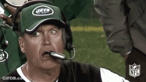 Man In Jets Hat And Headphones Looking At Camera GIF