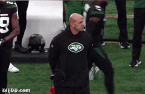 Man In Jets Sweatshirt Standing On Field GIF