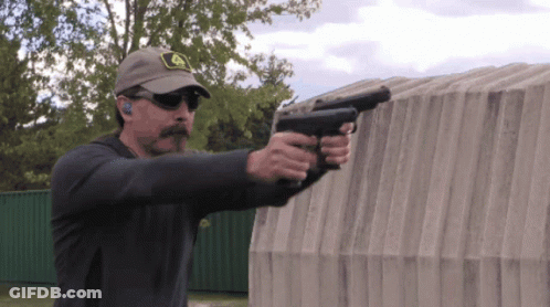 Man In John Deere Hat Holding Two Guns GIF