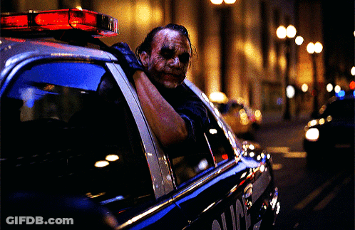 Man In Joker Mask In Police Car GIF