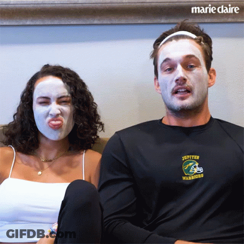 Man In Jupiter Warriors Shirt Beside Masked Woman GIF