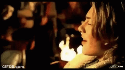 Man In Jupiter Warriors Shirt Beside Masked Woman GIF