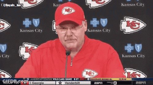 Man In Kansas City Hat In Front Of Kansas City Logos GIF