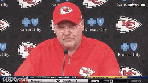 Man In Kansas City Hat Standing In Front Of Wall GIF