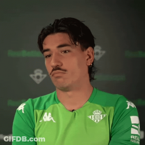 Man In Kappa Shirt Sitting At Table With Hands Folded GIF