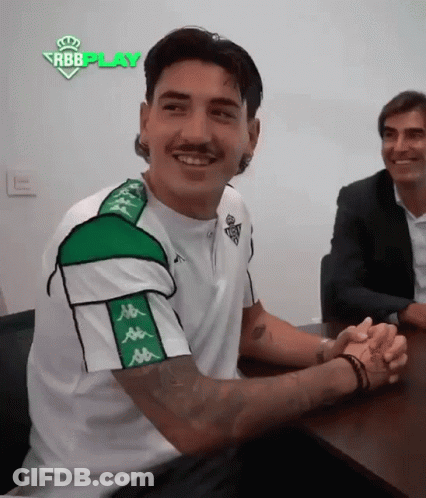 Man In Kappa Shirt Sitting With Hands Folded GIF
