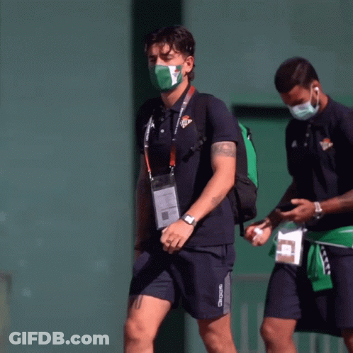 Man In Kappa Shirt Walking With Masked Man GIF