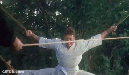 Man In Karate Uniform Doing Split With Rope GIF