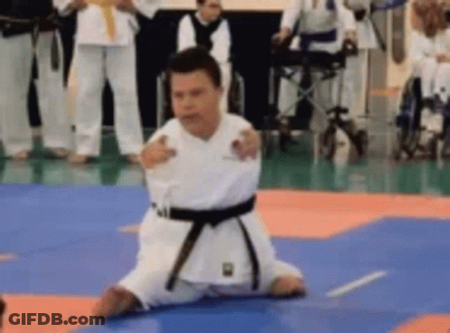 Man In Karate Uniform Kneeling GIF