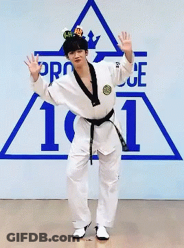 Man In Karate Uniform Standing On One Leg In Front Of Pro 101 Sign GIF