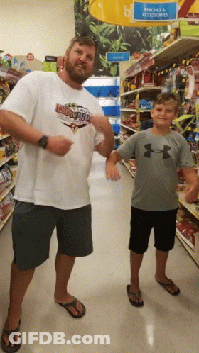 Man In Kid's Pro Shirt Next To Boy GIF