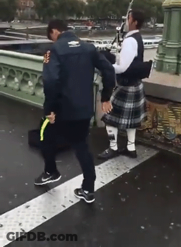 Man In Kilt Holding Hands With Man In Rugby Jacket GIF