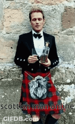 Man In Kilt Holding Whiskey Bottle And Glass GIF