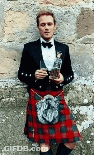 Man In Kilt Holding Whisky Bottle And Glass GIF