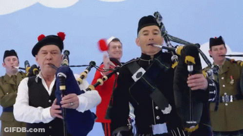 Man In Kilt Playing Bagpipe For Group Of Men GIF