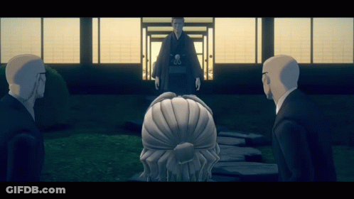 Man In Kimono Standing Before Men In Suits GIF