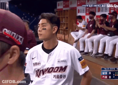 Man In Kingdom Jersey In Front Of Baseball Players GIF