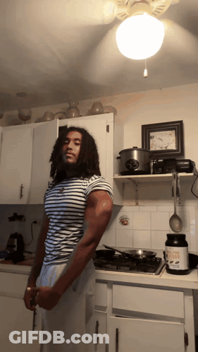Man In Kitchen Holding Knife And Protein GIF